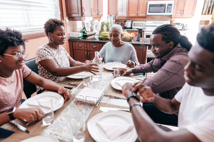 Three generation family sitting around the dinner table