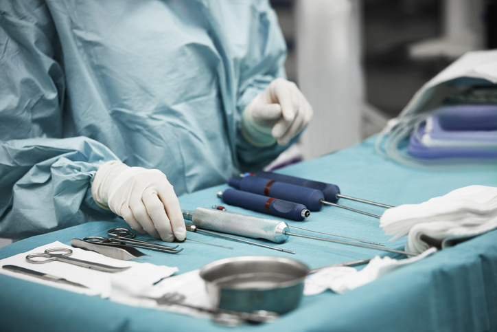 Female doctor arranging surgical equipment