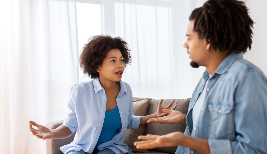 Unappy couple having an argument at home