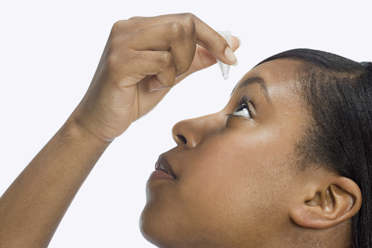 Woman using eye drops