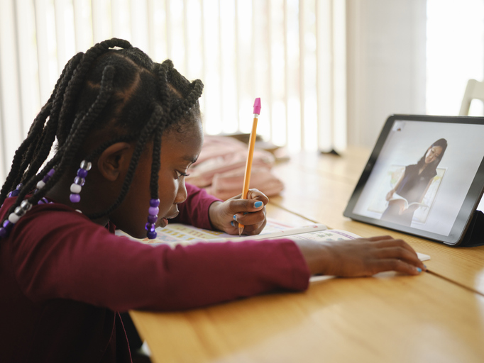 An Elementary School Student Working at Home