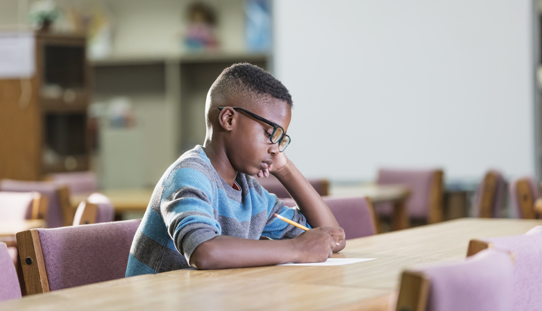 African-American boy in elementary school, writing