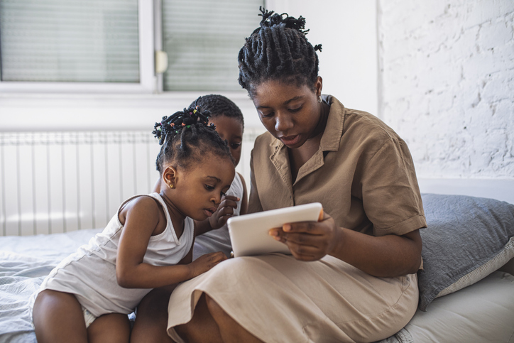 Mother With Boyo and Girl Looking at the Tablet