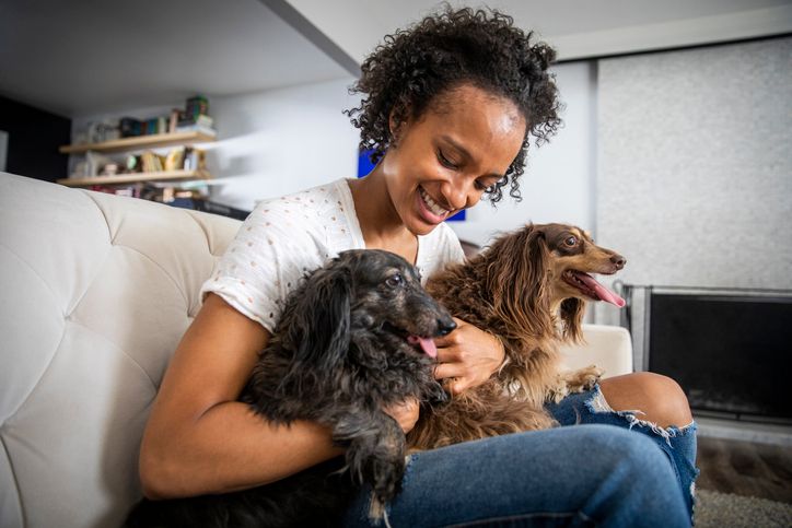 Young Black Woman with Pet Dachshunds
